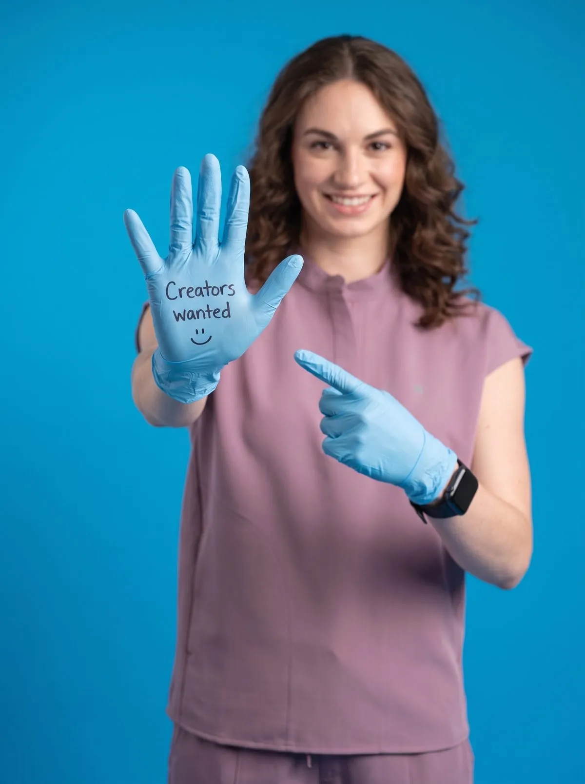 Model holding a glove that reads Creators wanted