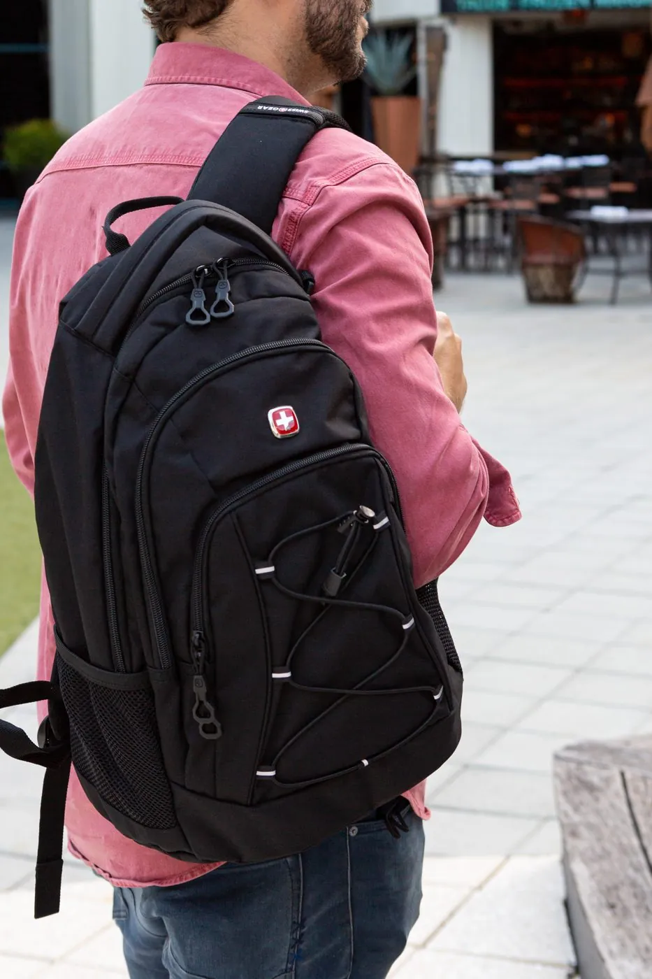 Man wearing a SwissGear backpack outdoors