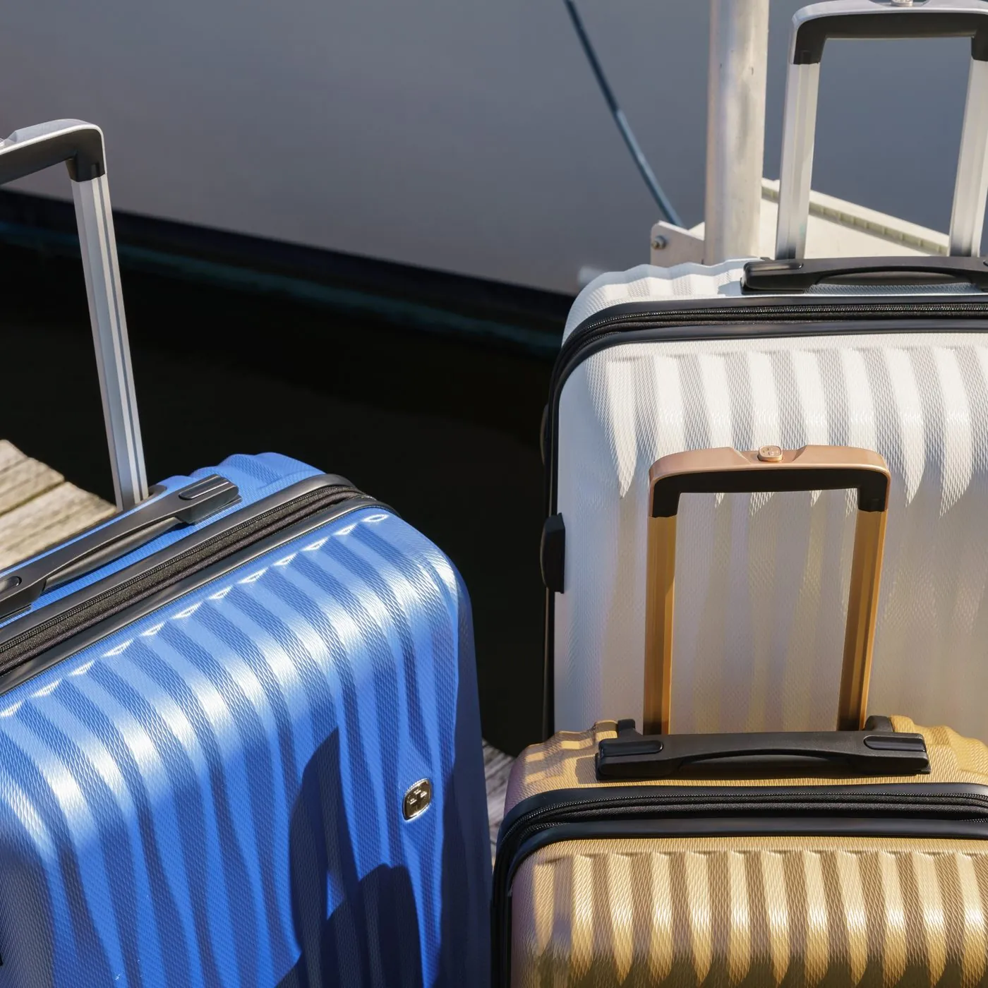 Close up of blue and gold SwissGear hardside luggage on a dock