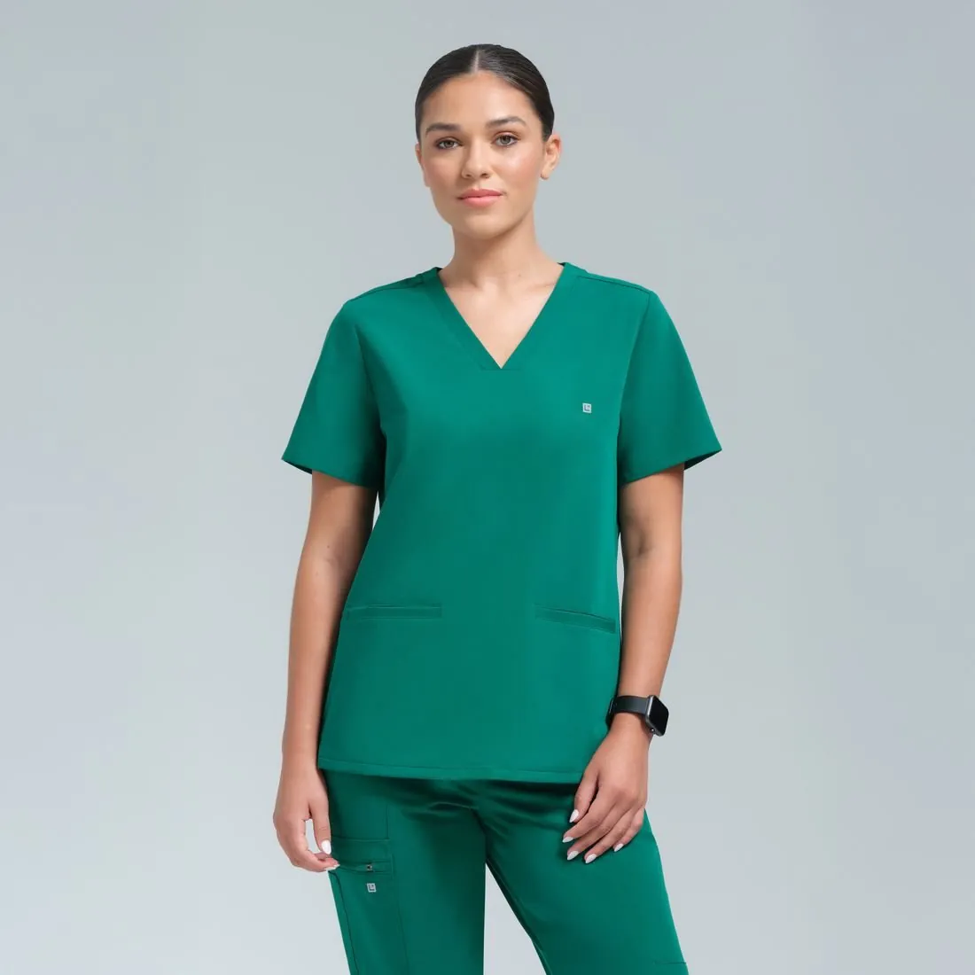 Athena three pocket top in Alpine Green on white