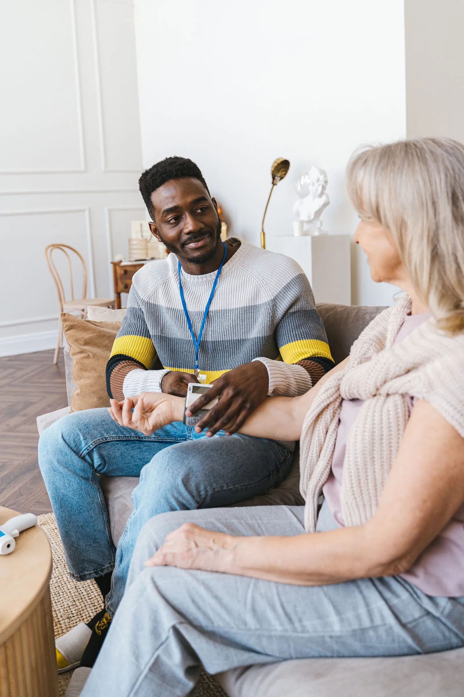 Homeable caregiver checking in with an older client at home